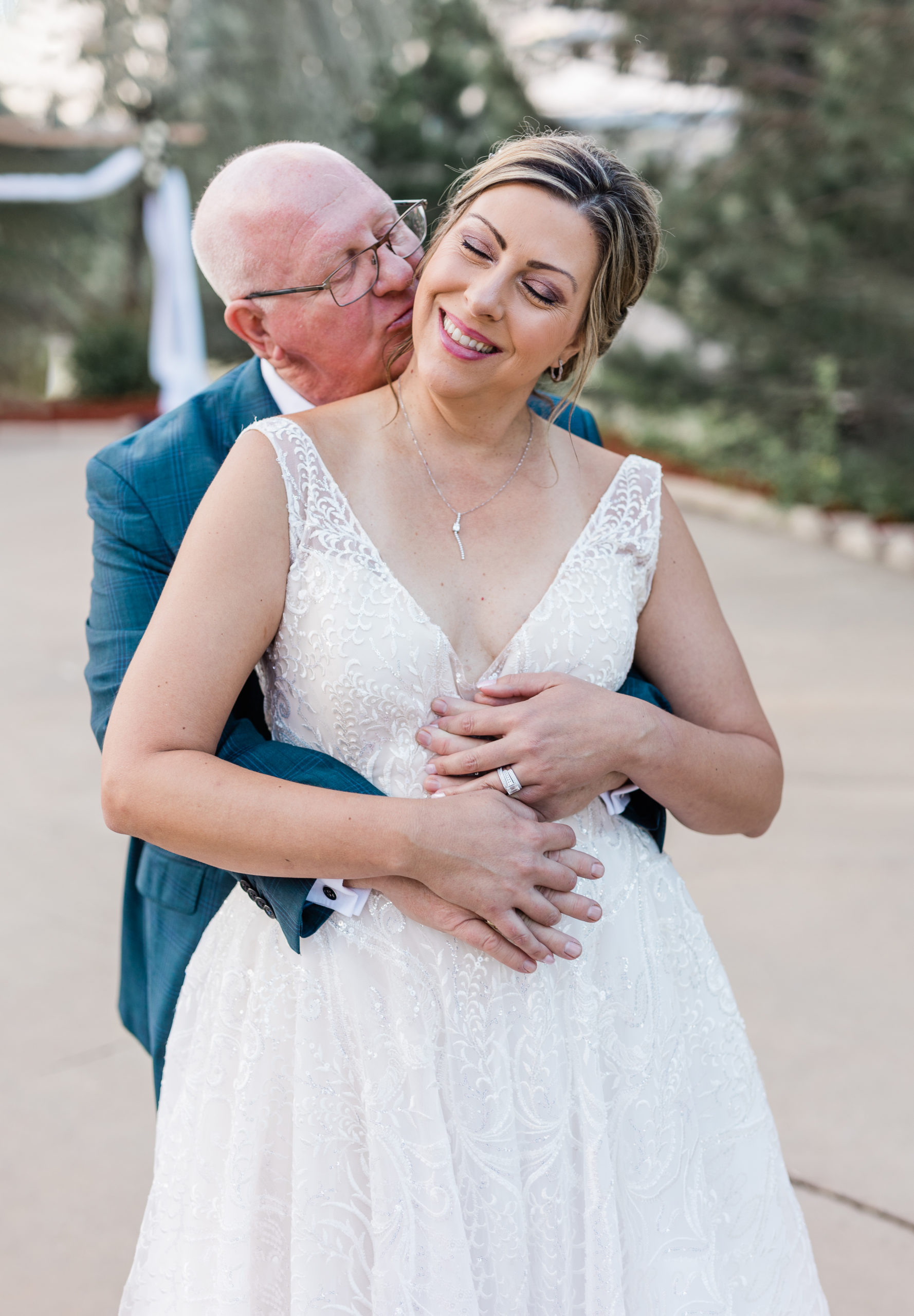 a bride and groom hugging each other on their wedding day.