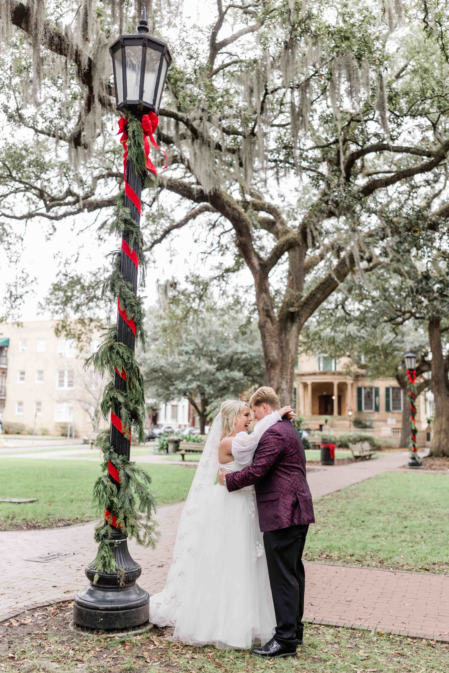 a bride and groom standing under a street light.