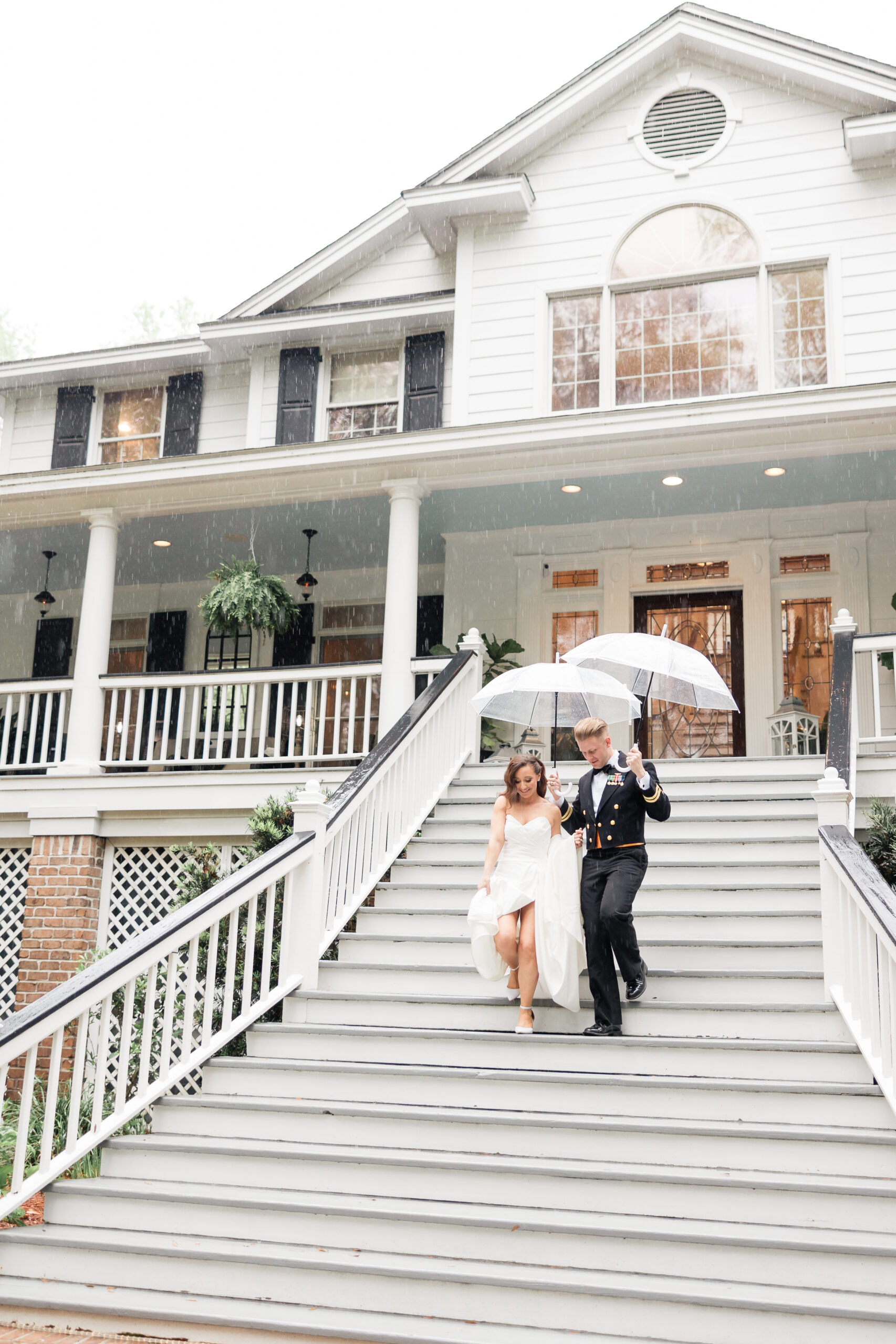 mackey house savannah wedding bride and groom walking downs steps with umbrella